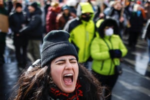 a person wearing a beanie shouts outside
