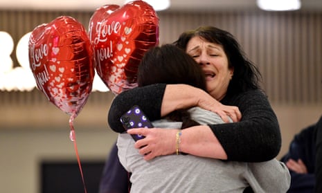 People embrace at Sydney airport as Australian nationals arrive from Israel on a repatriation flight