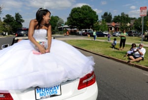 Rebekah Johnson, the 2008 Miss Juneteenth, rides down 26th Avenue on the back of a convertible during a Juneteenth parade in Denver, Colorado, in 2012.