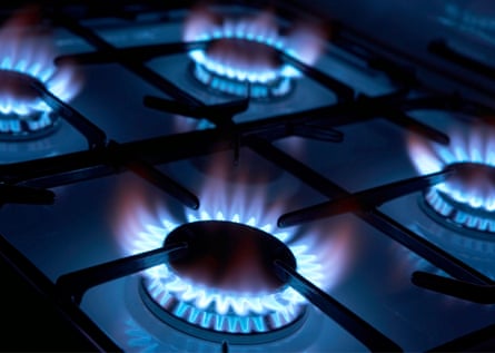 Four lit rings on a gas cooker