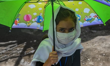 An Afghan school girl holding an umbrella, July 2021.