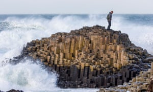A tourist visiting the Giant’s Causeway in Northern Ireland
