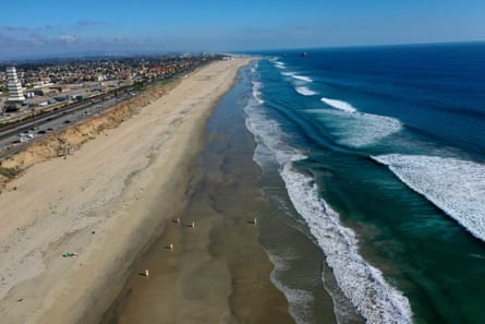 Environmental crews work to clean up a major oil spill at Huntington Beach, California Tuesday.