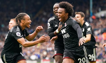 Willian (right) celebrates scoring Fulham’s third goal against Leeds at Elland Road.
