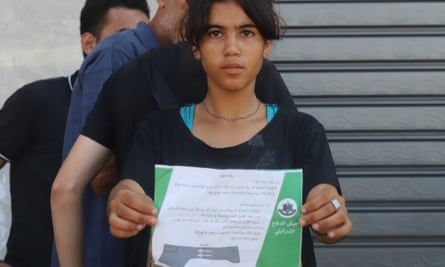 A girl holds a leaflet dropped from Israel army airplanes, warning residents of an ‘imminent attack’ on the Gaza Strip, 13 October 2023.