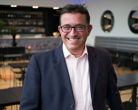 Lance Forman stands in a restaurant