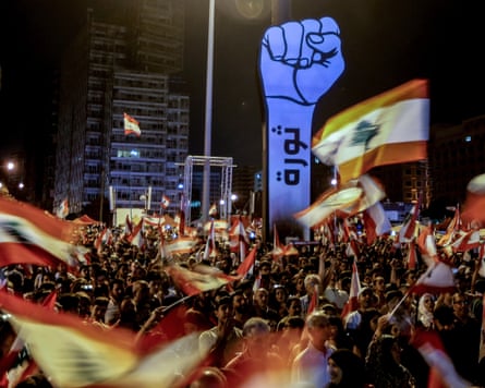 Protesters carry placards, wave Lebanese flags, and shout anti-government slogans during a protest in martyr square in downtown Beirut, Lebanon, 27 October 2019. Thousands continued to protest on the second week of demonstrations against proposals of tax hikes and state corruption, and calling for the resignation of the government. EPA/NABIL MOUNZER