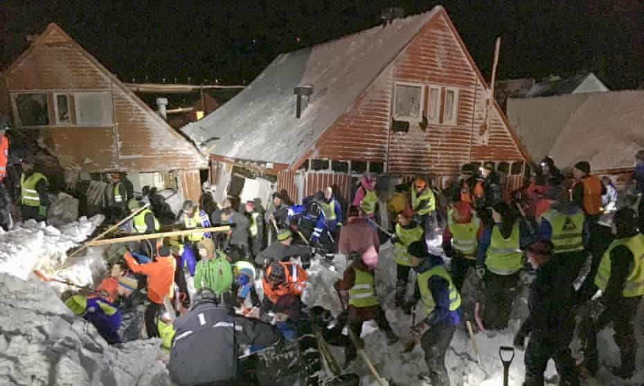 Search crews with shovels worked to free people from buried houses after an avalanche hit several houses in Longyearbyen, Norway.