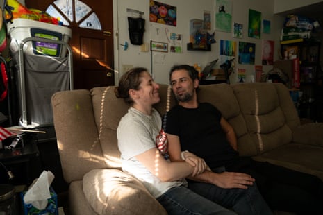 A man and a woman sitting together on a couch.