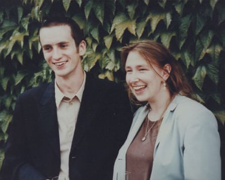 Head and shoulders view of man in dark suit jacket, and woman in pale blue jacket
