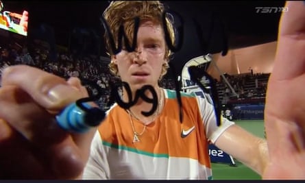 Tennis player Andrey Rublev of Russia writes ‘No War Please’ on a camera lens at the Dubai Tennis Championships.