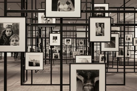A gallery with dozens of photos exhibited on metal scaffolding.