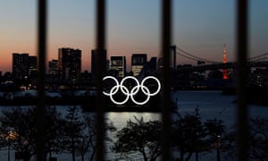 The Olympic rings pictured through a fence in Tokyo.