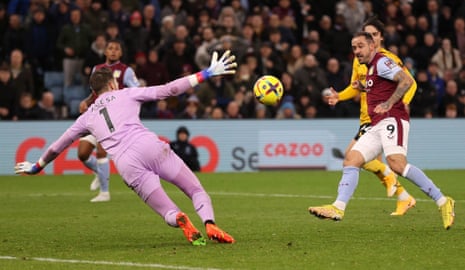 Aston Villa’s English striker Danny Ings (right) scores past Wolves’ keeper Jose Sa to put the home side level.
