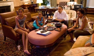The Obamas watch TV at home in the White House residence in 2011, photographed by Pete Souza.