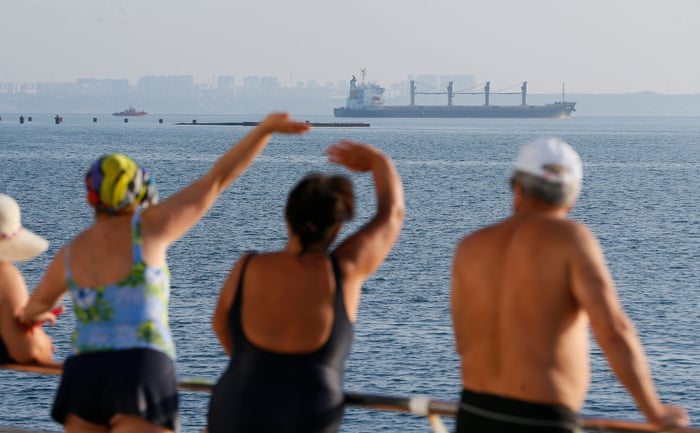 People watch cargo vessel Navi Star carrying 33,000 tonnes of corn bound for Ireland leaves the port of Odesa, Ukraine on Friday.
