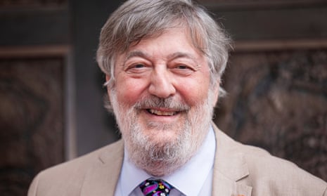 Stephen Fry poses for photographers upon arrival at the National Portrait Gallery re-opening in 2023.