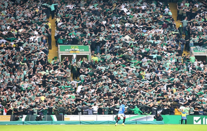 Celtic fans turn their backs as Rangers' Alfredo Morelos passes.
