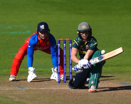 Australia batter Ellyse Perry kneels to play a reverse paddle sweep, with England wicket-keeper Amy Jones in position behind her, during their Women’s T20 World Cup warm-up game at Cardiff.