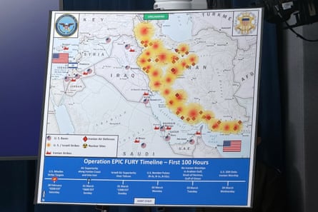 A Department of Defense map entitled, Operation Epic Fury Timeline – First 100 Hours is propped up on display.