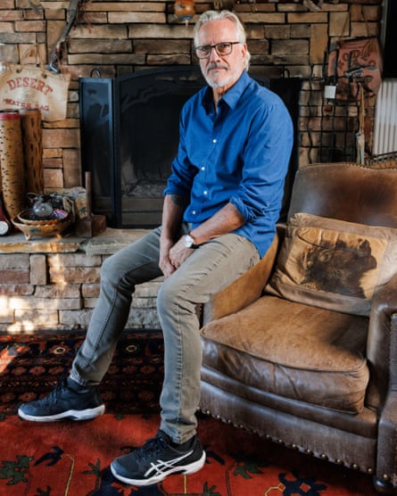 Christopher Duddy perches on the armrest of a chair at his home in Los Angeles, 2025.