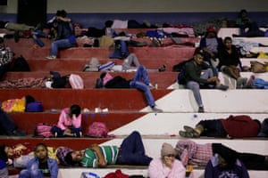 Hondurans fleeing poverty and violence sleep in a public gym, as they are part of a caravan moving towards the United States, in Santa Rosa de Copan, Honduras.