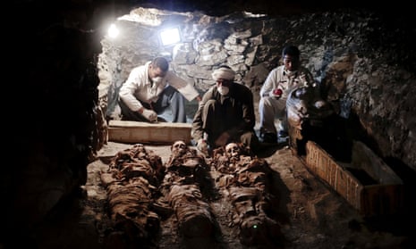 Archaeologists work on mummies found in the New Kingdom tomb in the Valley of the Kings, Egypt