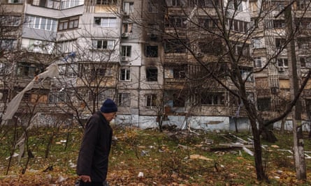 A man walks past a damaged residential building in Kherson, southern Ukraine.