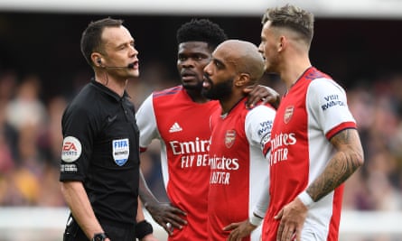 Arsenal players confront Stuart Attwell during their 2-1 Premier League defeat by Manchester City