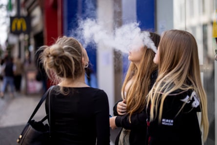 Three teenage girls vaping.