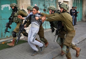 Israeli soldiers detain a Palestinian during clashes at a protest in Hebron.
