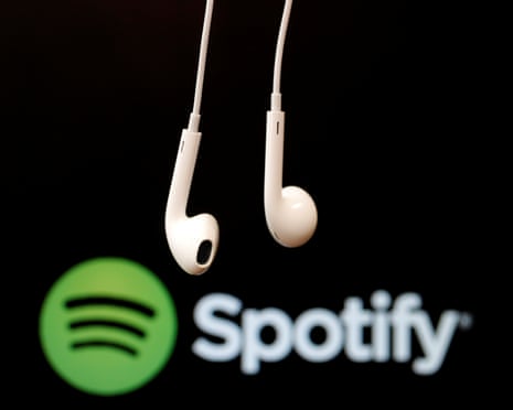Spotify logo behind a pair of earbuds