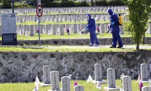 Quarantine officials disinfect as a precaution against the new coronavirus at the National Cemetery in Seoul, South Korea, Monday, 1 June 2020.