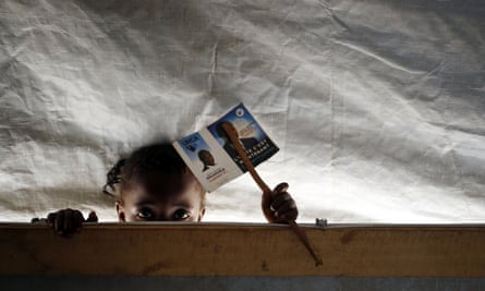 A child peers into a classroom in a school set in the Mpoko refugee camp in Bangui, Central African Republic