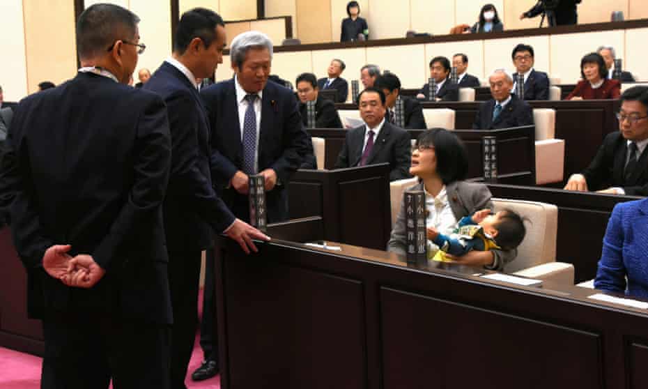 Yuka Ogata and her infant son in the chamber of Kumamoto municipal assembly.
