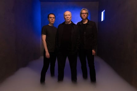 Three men, each dressed successful black.