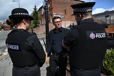 Andy Burnham speaks to two police officers