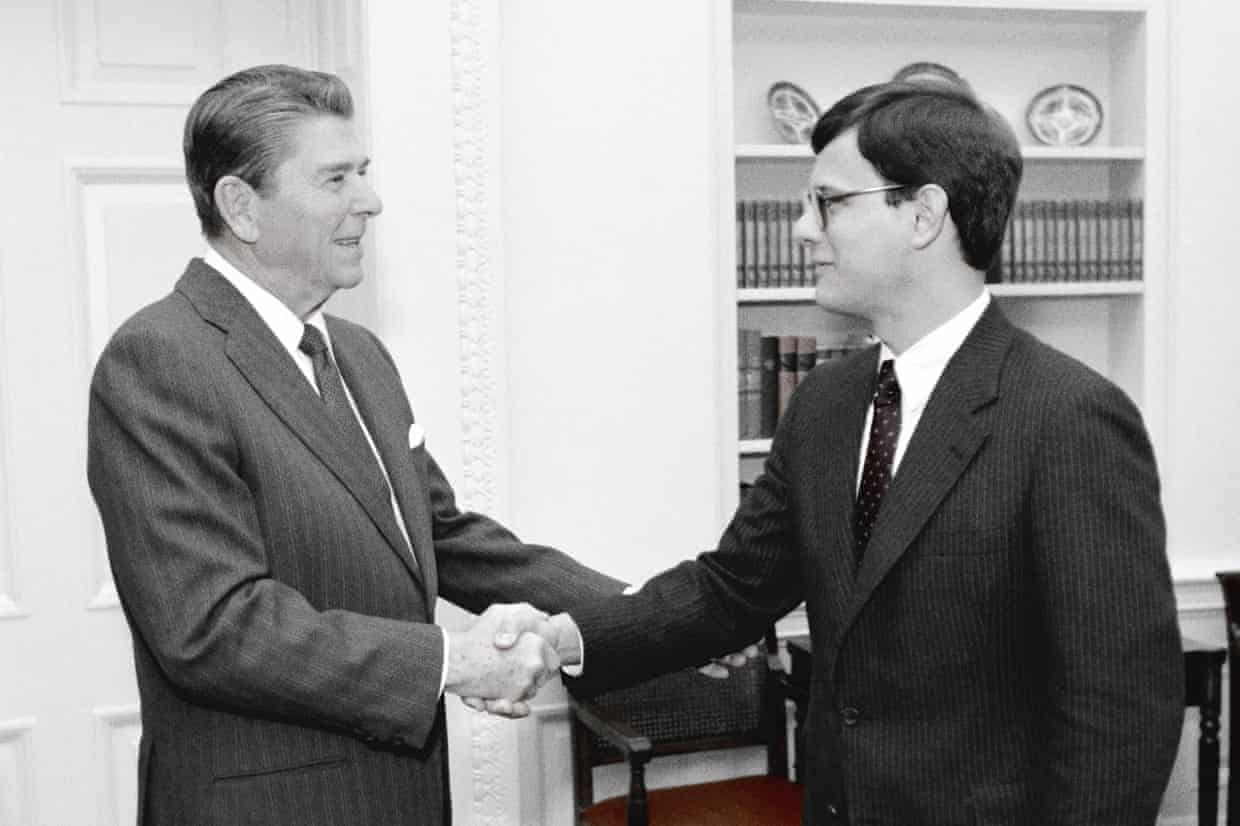 Ronald Reagan shakes the hand of a young man in the Oval Office