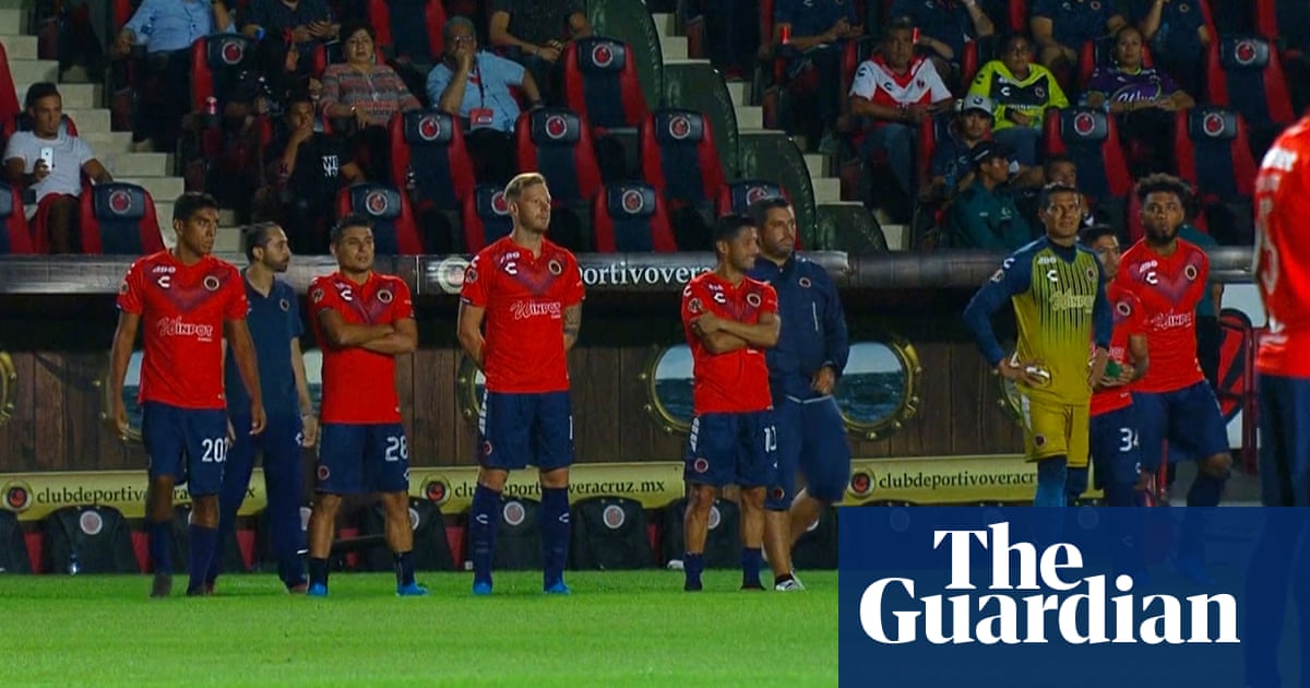 Players protest unpaid wages by standing still in Mexican football match – video