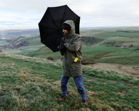Pete stands on a windy hilltop with a black Davek Elite umbrella