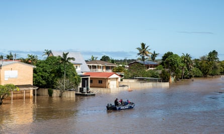 Police rescue boat going down a flooded street in Ballina NSW