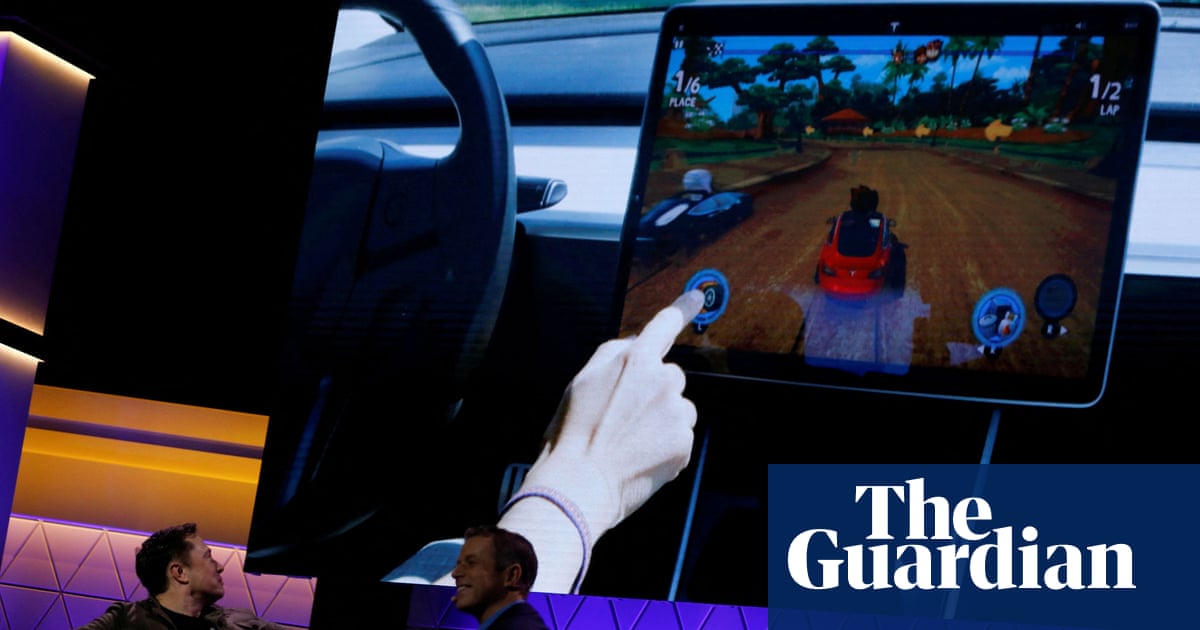 US investigates claim Tesla drivers can play video games while driving