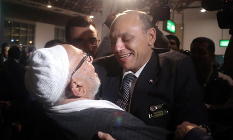 Egyptair pilot, Captain Amr al-Jamal, right, and a passenger of the hijacked Airbus A-320 embrace after they arrive at Cairo international airport.