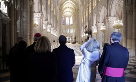 Emmanuel Macron (centre) and Brigitte Macron inspect the renovation work at Notre Dame
