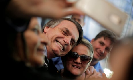 Jair Bolsonaro poses for a selfie at the National Congress in Brasilia during the campaign