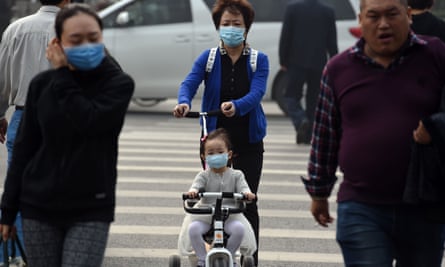 A woman and child wear masks on a polluted day in Beijing, October 2014.