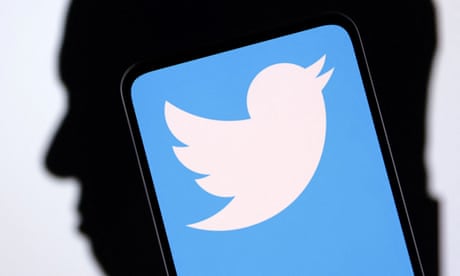 Illustration shows Twitter logo on phone screen with man’s face silhouetted in background