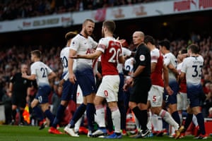 Tottenham Hotspur's English defender Eric Dier and Arsenal's German defender, Shkodran Mustafi, after Dier celebrates his equalizer.