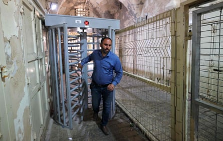 The Palestinian activist Issa Amro, who is featured in The Settlers, walking through an Israeli checkpoint in Hebron in 2021.