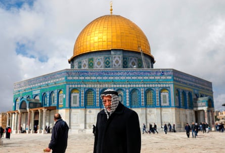 A Palestinian worshipper walks past the Dome of the Rock Mosque in Jerusalem.